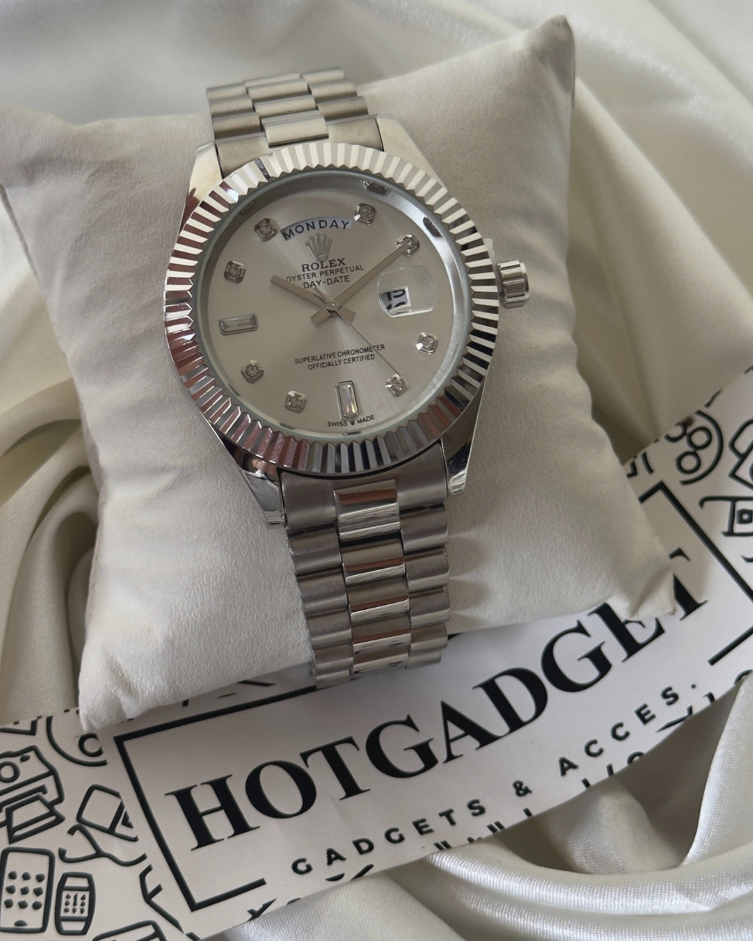 white gold Rolex Oyster Perpetual Day-Date with a fluted bezel, white dial with diamond hour markers, and a President bracelet.
