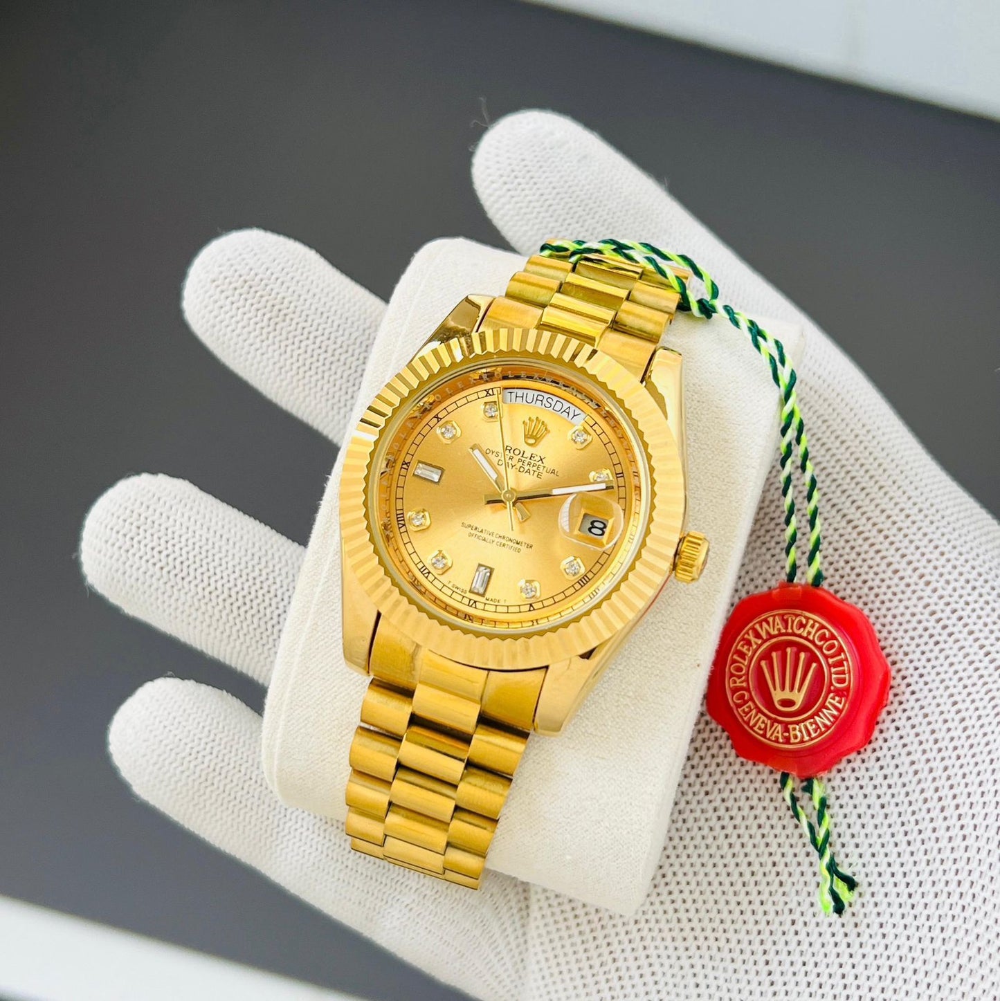 Rolex Oyster Perpetual Day-Date watch in 18 ct yellow gold with diamond hour markers and a fluted bezel.