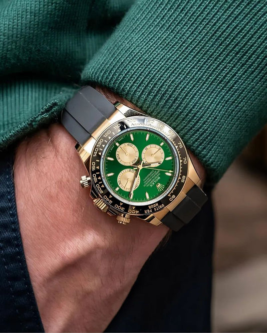 Rolex Cosmograph Daytona in 18k yellow gold with a green dial and a black Oysterflex (rubber) bracelet.