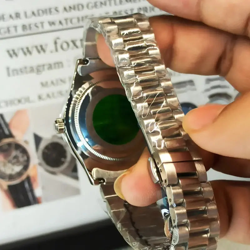 Rolex Day-Date watch with a blue dial, diamond hour markers, and a stainless steel President bracelet.