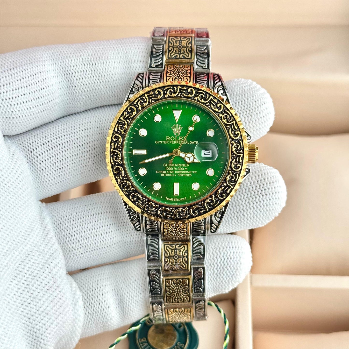 Rolex custom-engraved Rolex Submariner with a green dial, bezel, and a two-tone (gold and silver-colored) band.
