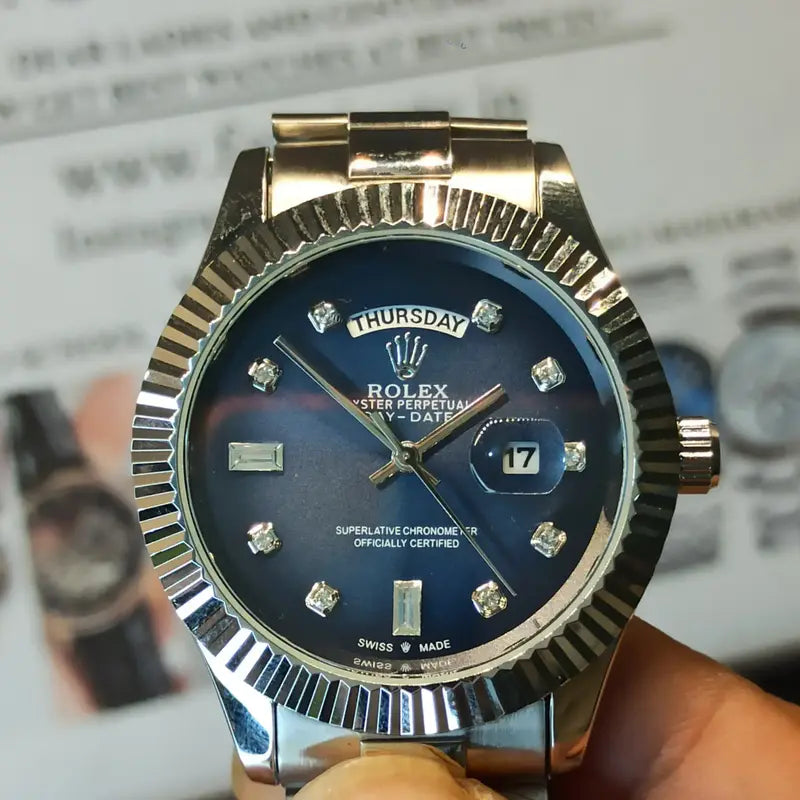 Rolex Day-Date watch with a blue dial, diamond hour markers, and a stainless steel President bracelet.