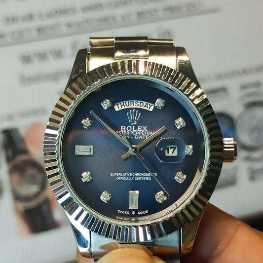 Rolex Day-Date watch with a blue dial, diamond hour markers, and a stainless steel President bracelet.