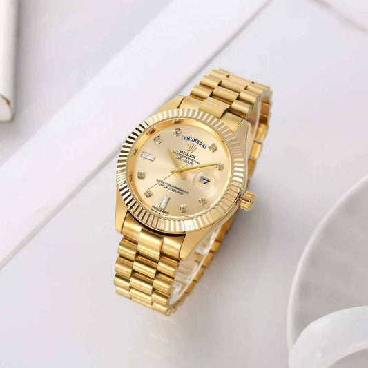 Rolex Oyster Perpetual Day-Date watch in 18 ct yellow gold with diamond hour markers and a fluted bezel.