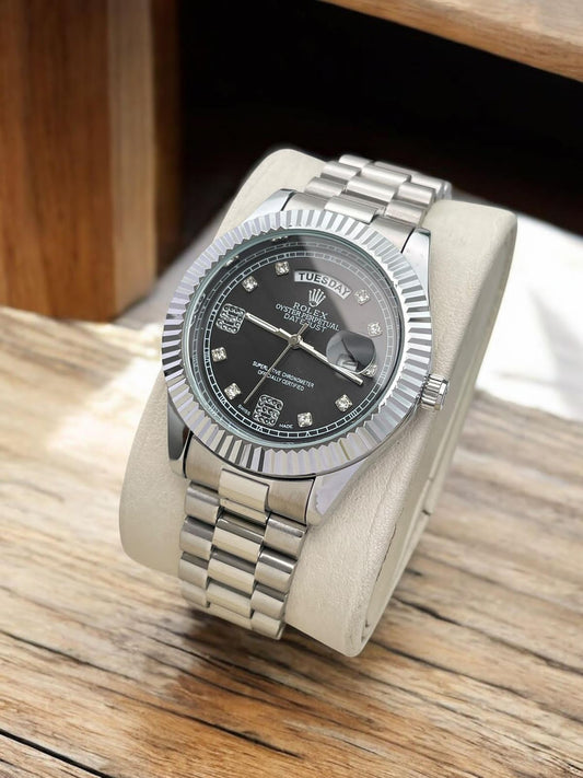 Rolex Day-Date watch with a black dial and a fluted bezel on a President-style bracelet.