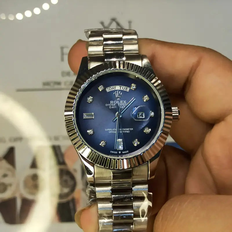 Rolex Day-Date watch with a blue dial, diamond hour markers, and a stainless steel President bracelet.