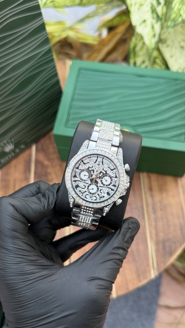 Rolex Daytona "Eye of the Tiger" watch in a silver-tone case and bracelet with a diamond-set bezel and an intricate black and silver dial.