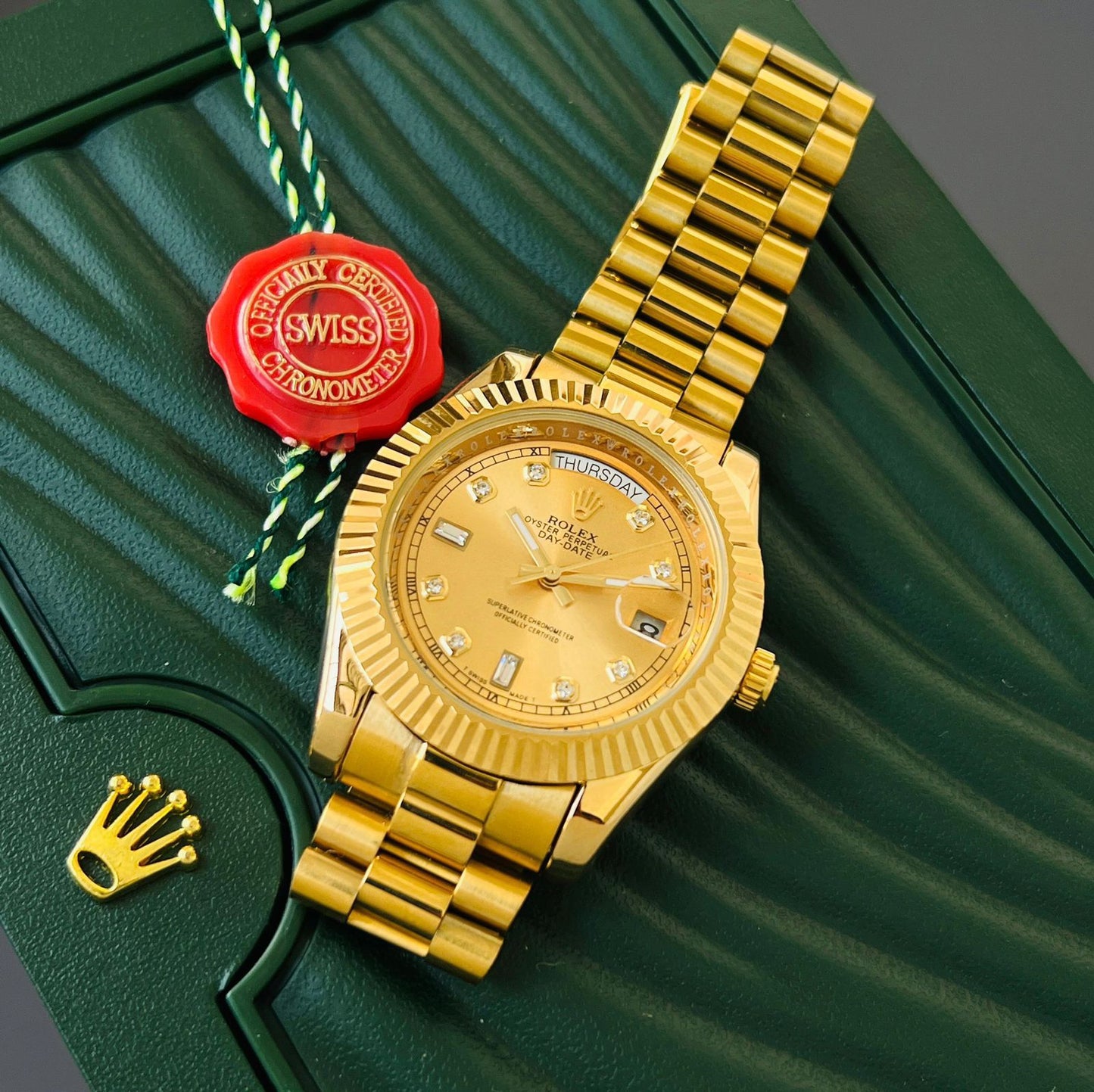 Rolex Oyster Perpetual Day-Date watch in 18 ct yellow gold with diamond hour markers and a fluted bezel.