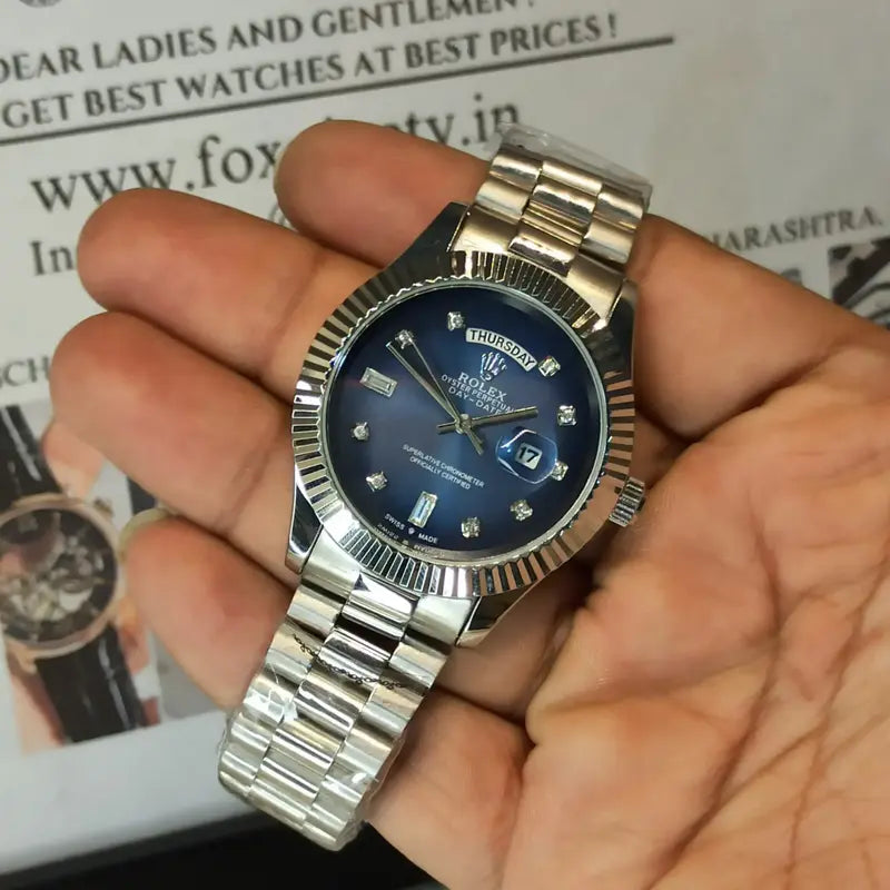 Rolex Day-Date watch with a blue dial, diamond hour markers, and a stainless steel President bracelet.