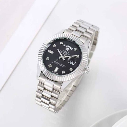 Rolex Day-Date watch with a black dial and a fluted bezel on a President-style bracelet.