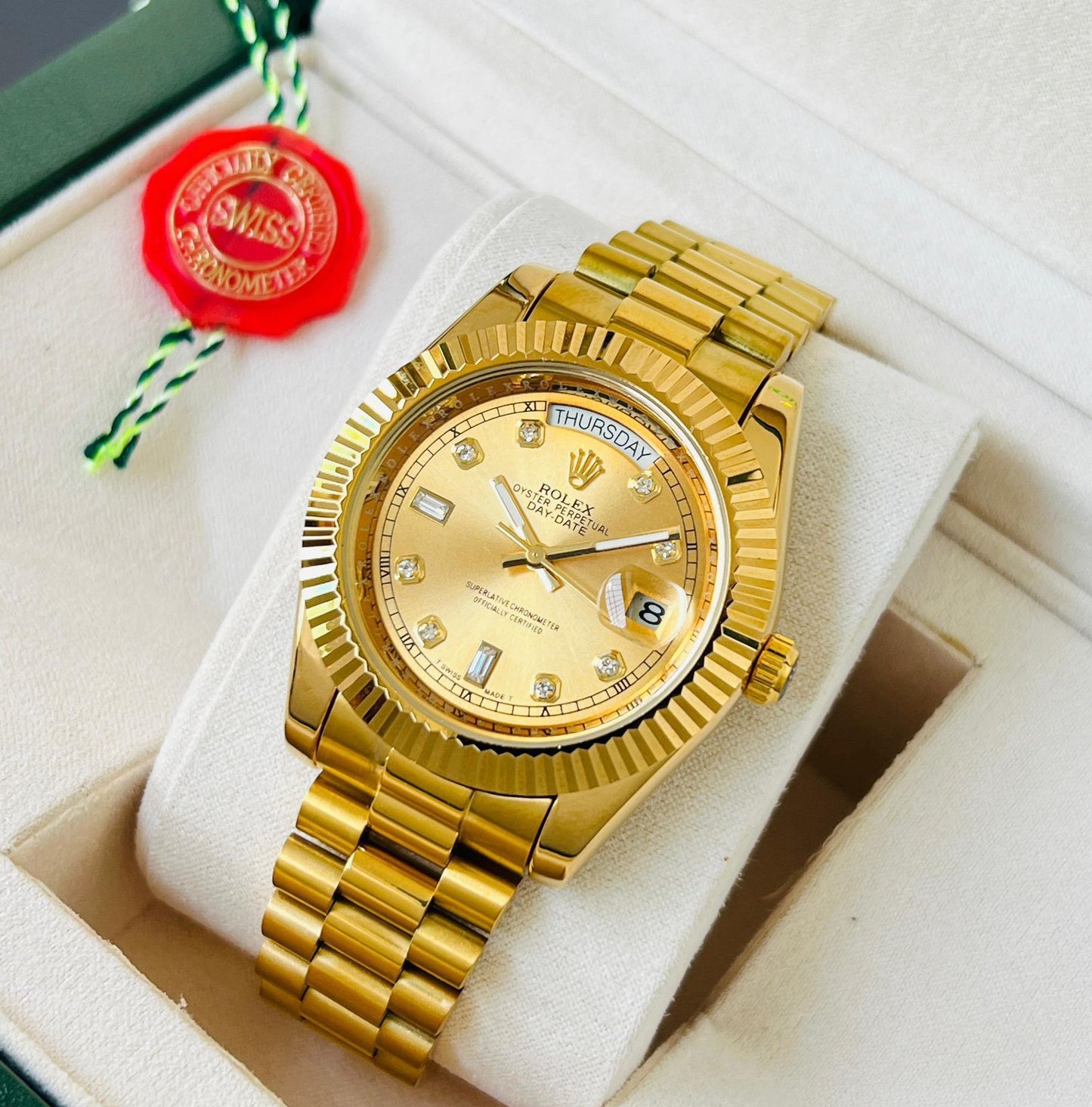 Rolex Oyster Perpetual Day-Date watch in 18 ct yellow gold with diamond hour markers and a fluted bezel.